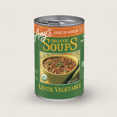 The 10 Healthiest Canned Soups 8 A Can Of Amy’s Organic Soups Lentil Vegetable Flavor, Labeled “Light In Sodium,” Showcases An Image Of The Soup In A Bowl And Is Certified Organic—Perfect For Those Seeking The Healthiest Canned Soup Option.