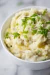 bowl of mashed potatoes with butter and chives
