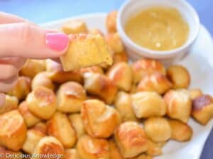 Close Up Showing A Pretzel Bite Dipped Into The Sweet And Spicy Mustard