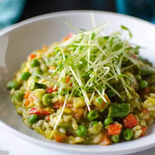Spring Risotto with Pea Coulis 6 A Vibrant Bowl Of Spring Risotto With Pea, Garnished With Finely Grated Cheese And Fresh Herbs, Ready To Be Savored.