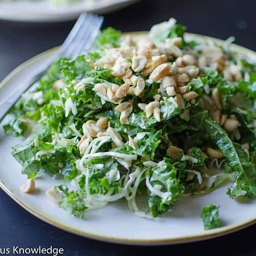 Nourishing Kale Peanut Salad 3 A Fresh Kale And Peanut Salad Topped With Shredded Cheese, Ready To Be Enjoyed.