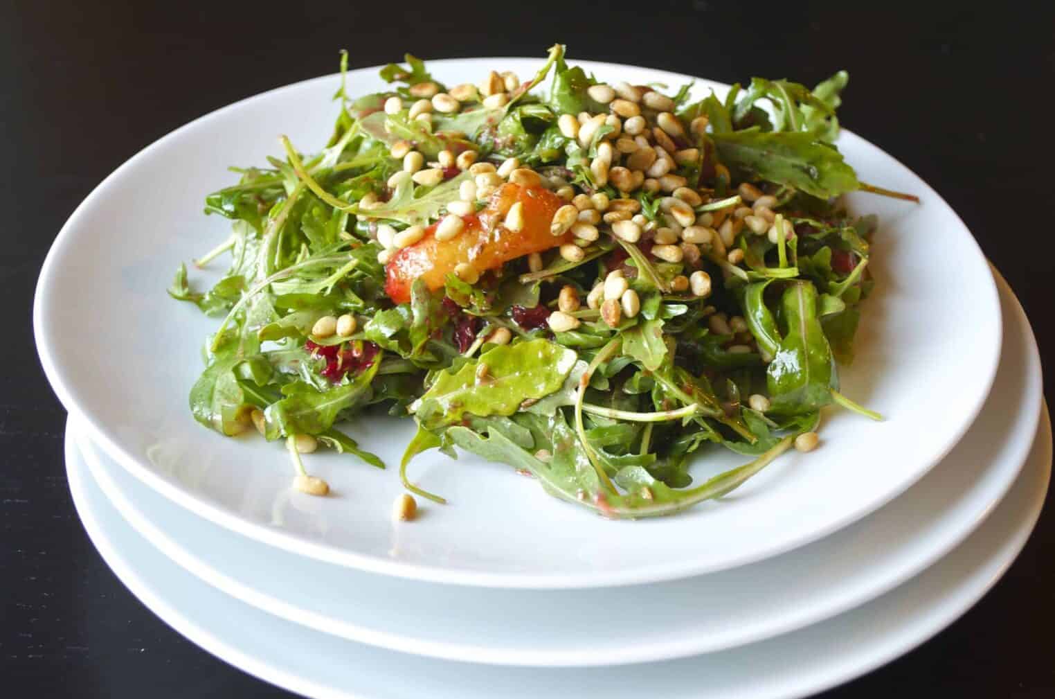 A healthy recipe of grilled plum and arugula salad with toasted pine nuts. Vegan and gluten-free. 