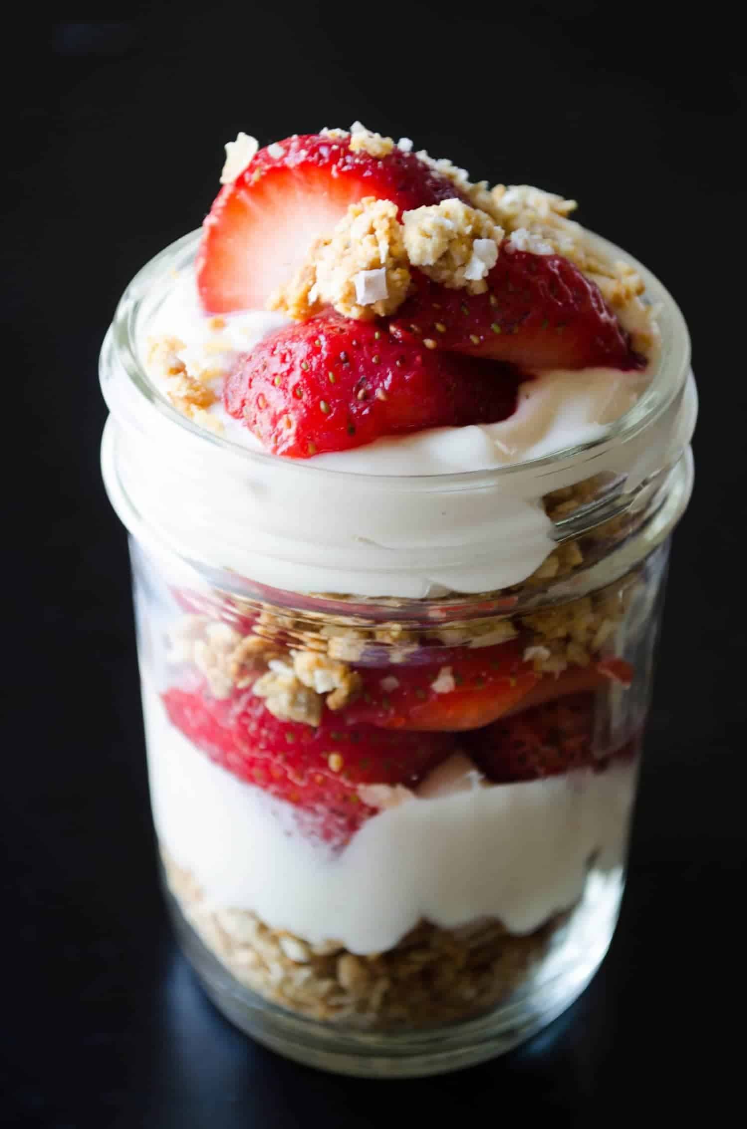 Vegan Strawberry Cheesecake Parfaits! Cheesecake filling layered with nut clusters and fresh berries. 
