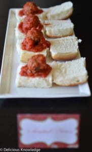 Perfect appetizer for the upcoming holiday season! Homemade vegan meatballs baked in tomato sauce. Served on slider buns. 
