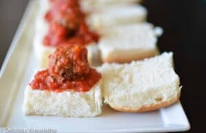 Perfect appetizer for the upcoming holiday season! Homemade vegan meatballs baked in tomato sauce. Served on slider buns. 