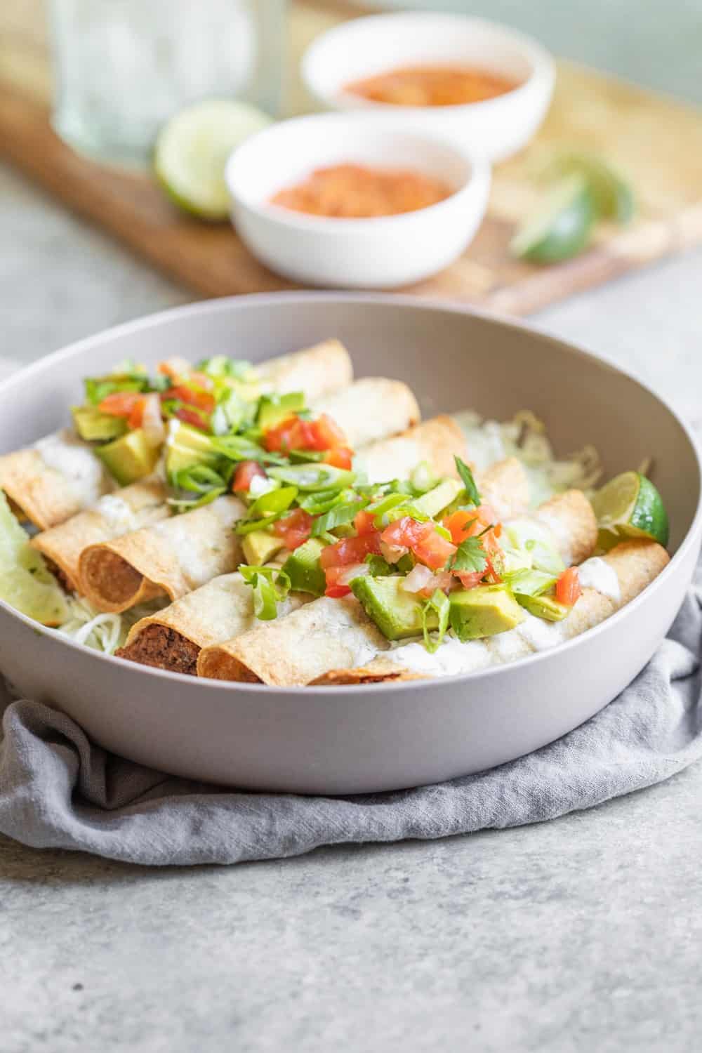 Vegan Taquitos in a bowl with toppings