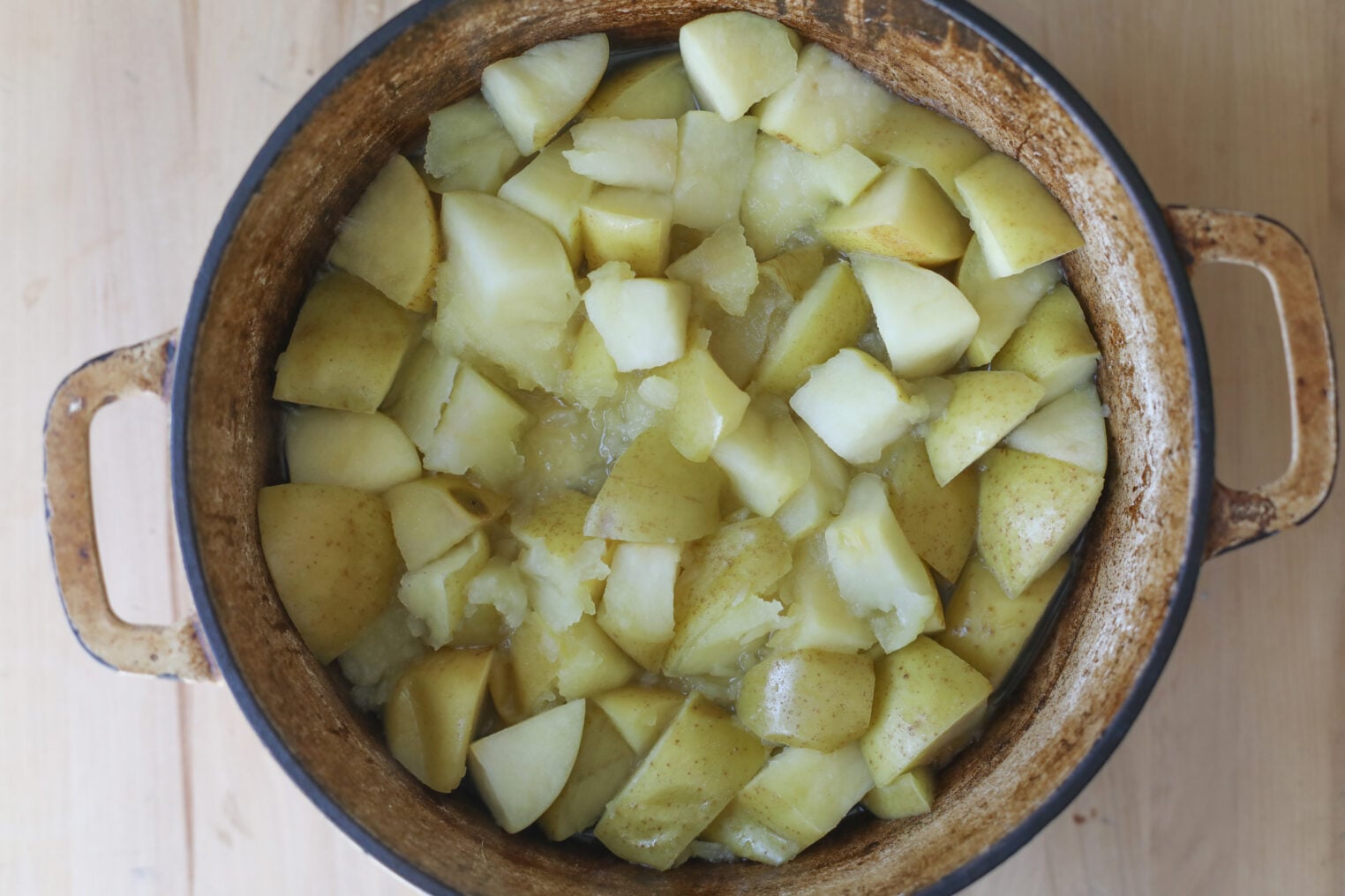 A Pot Filled With Chopped, Cooked Potatoes With Skins On, Sitting On A Wooden Surface, Ready To Be Paired With A Generous Dollop Of Apple Butter.