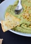 You've got to make this dip! Avocado Pesto Hummus with homemade parmesan crisps. | www.delishknowledge.com