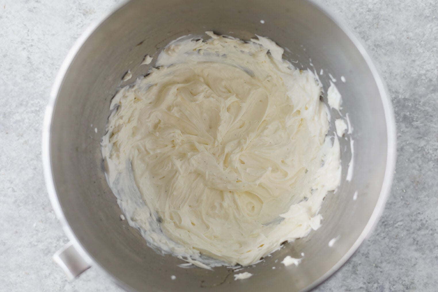 Berry Icebox Cake 4 A Metal Mixing Bowl Containing Creamy, Whipped Frosting Or Batter For A Delicious Berry Icebox Cake, Viewed From Above On A Light Gray Countertop.