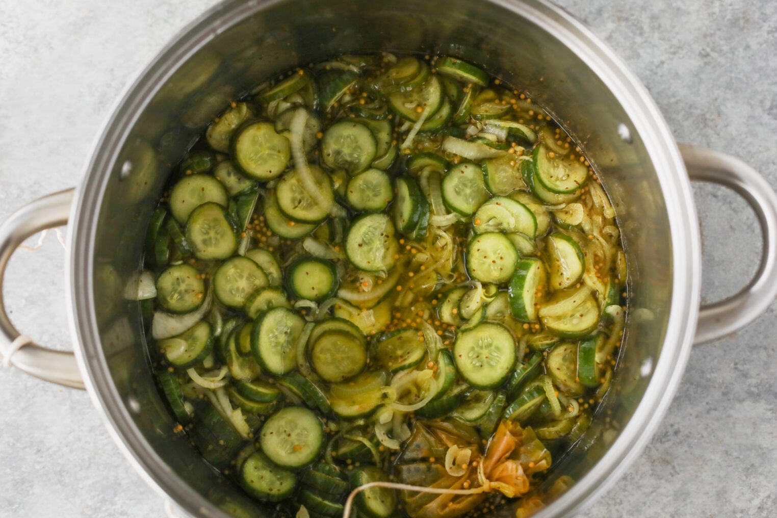 Sliced Cucumbers And Onions With Spices Are Soaking In Brine In A Large Stainless Steel Pot, Preparing To Become Delicious Bread And Butter Pickles.