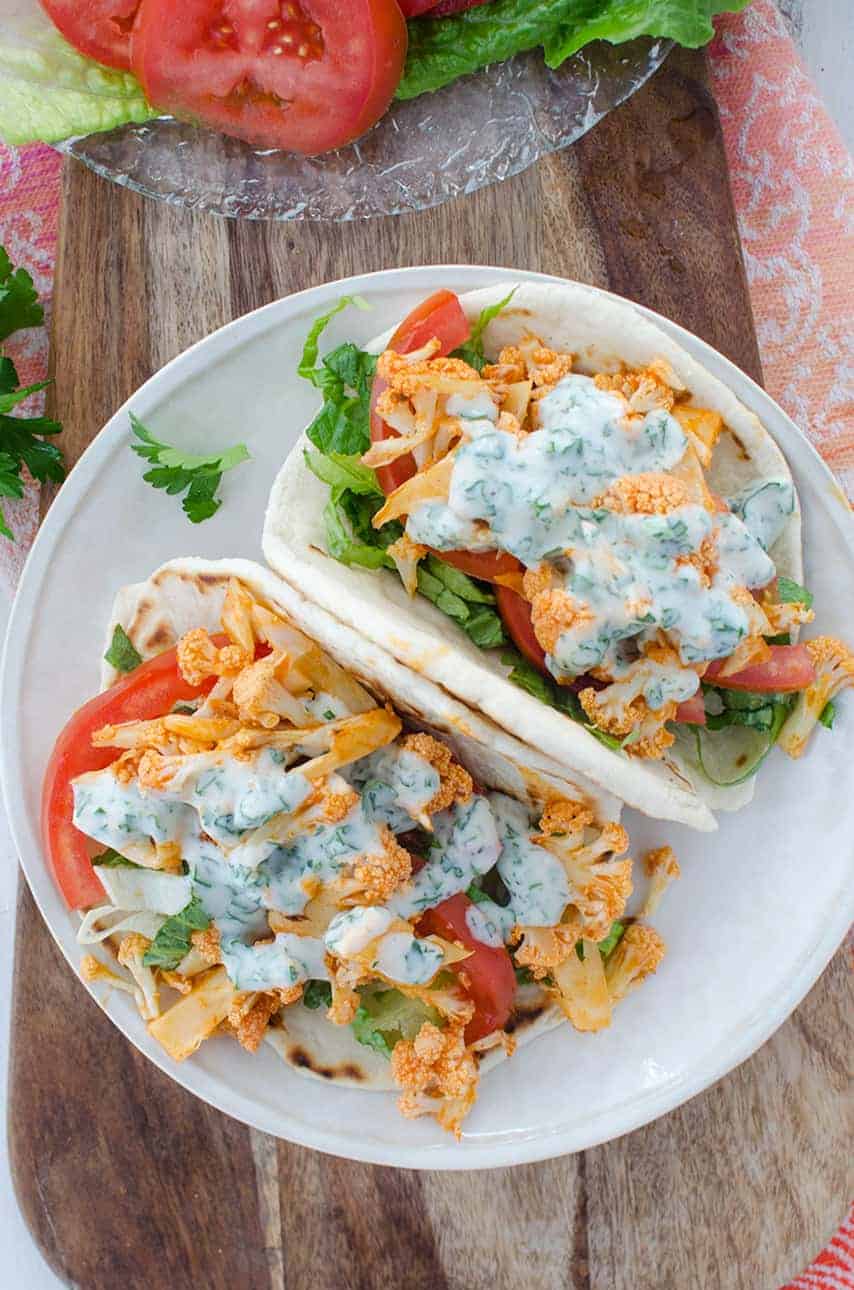 Buffalo Cauliflower Flatbreads! These Vegan Sandwiches Are Packed With So Much Flavor! Roasted Buffalo Cauliflower On Homemade Flatbreads. Topped With A Simple Dairy-Free Ranch Dressing. | Www.delishknowledge.com