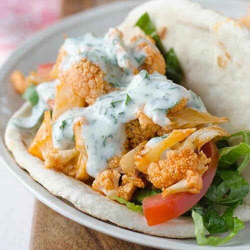 Buffalo Cauliflower Flatbreads! These Vegan Sandwiches Are Packed With So Much Flavor! Roasted Buffalo Cauliflower On Homemade Flatbreads. Topped With A Simple Dairy-Free Ranch Dressing. | Www.delishknowledge.com