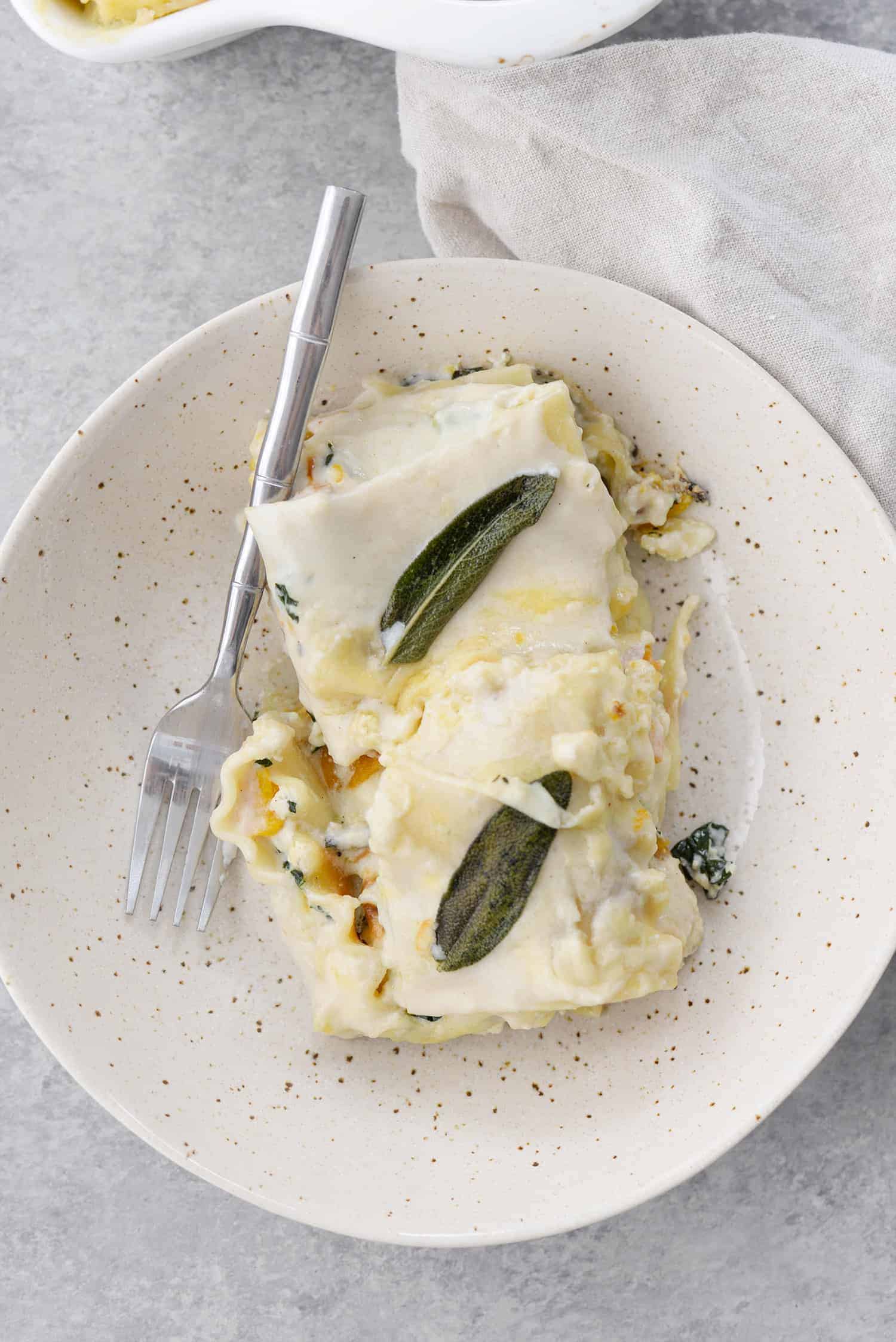 Butternut Squash and Kale Lasagna 2 Butternut Squash And Kale Lasagna! Save This One For The Holidays. Layers Of Flavors! Homemade Béchamel Sauce, Roasted Squash, Crispy Garlic Kale And Fontina Cheese. A Must Make. | Www.delishknowledge.com #Christmas #Vegetarian #Thanksgiving #Lasagna #Butternutsquash #Healthy #Healthyrecipe