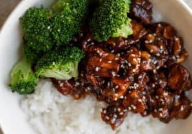 stir fry with broccoli, tofu and cashews in a bowl with rice