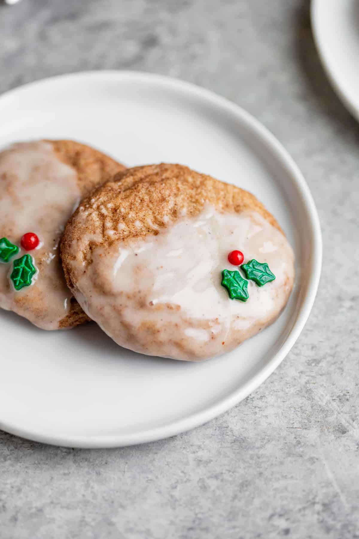 Two Vegan Sugar Cookies With Eggnog Glaze And Holly Decoration