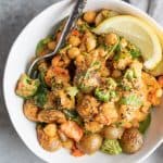 bowl of veggies and potatoes with harissa sauce