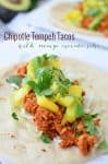 Chipotle Tempeh Tacos! Sauteed tempeh with a spicy chipotle sauce. Topped with a quick mango-pineapple-avocado salad. Vegan & Gluten-Free option.