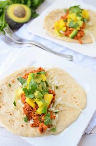 Chipotle Tempeh Tacos! Sauteed tempeh with a spicy chipotle sauce. Topped with a quick mango-pineapple-avocado salad. Vegan & Gluten-Free option. 