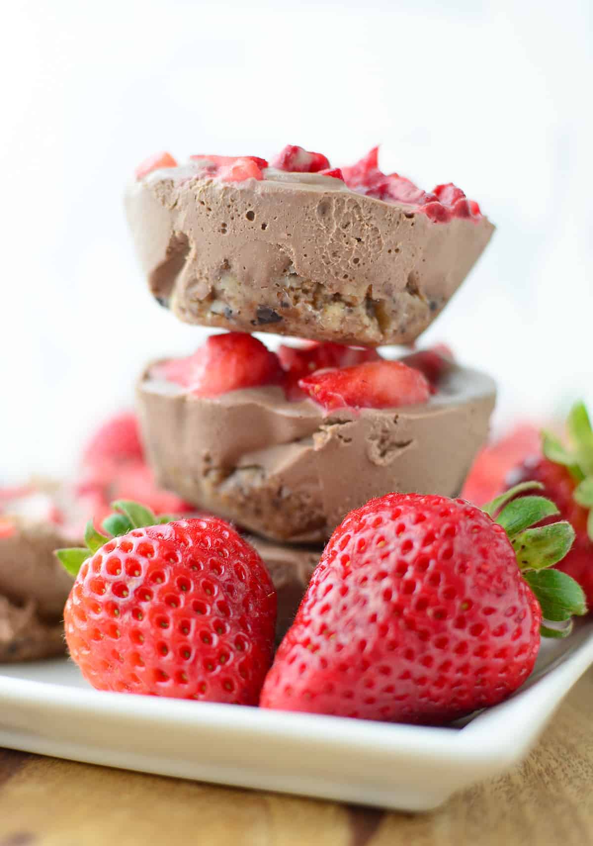 A Stack Of The Chocolate Strawberry Cheesecake Bites