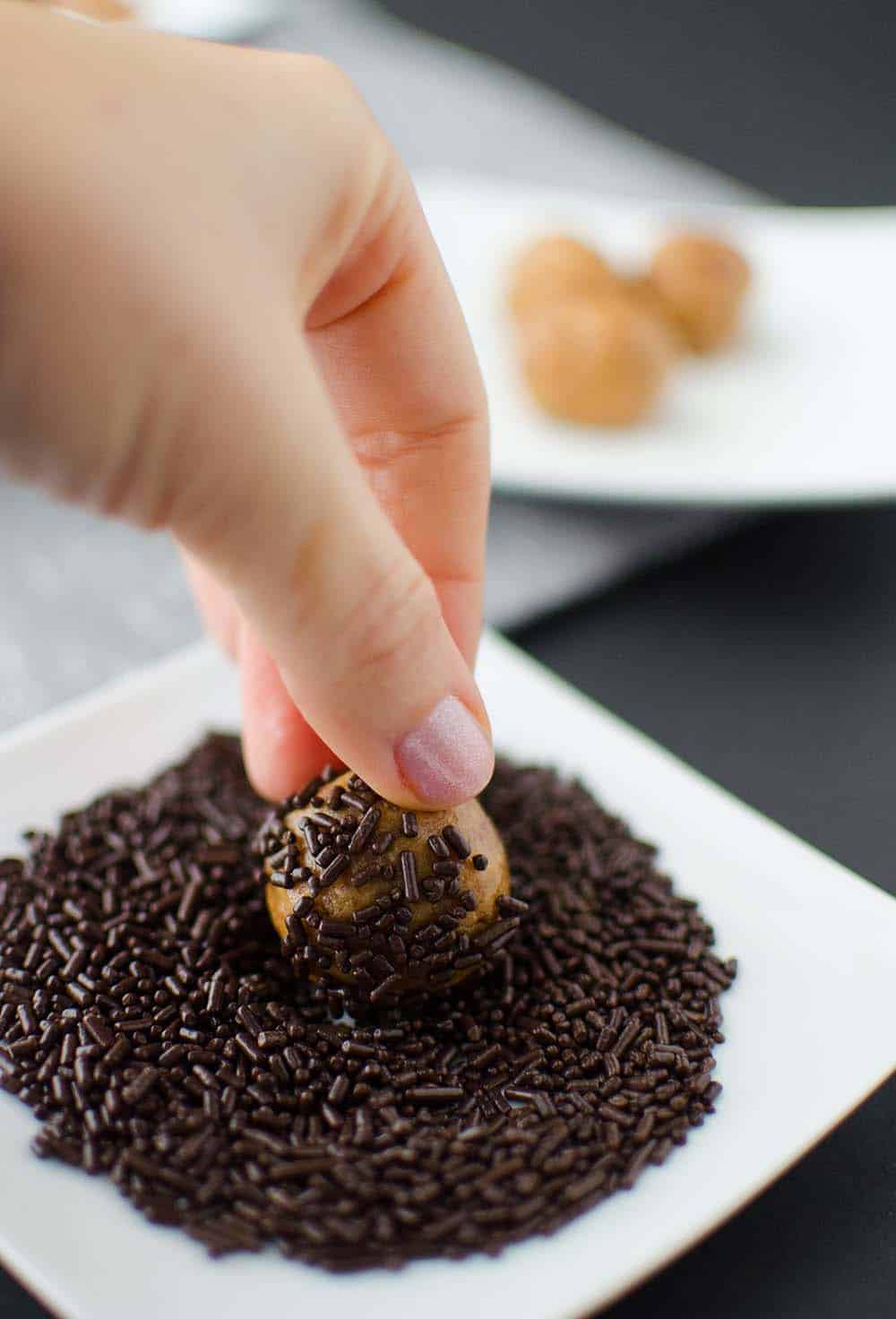 Rolling The Peanut Butter Truffles In Chocolate Sprinkles For Added Sweetness!