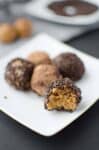 Naturally sweetened chocolate peanut butter truffles! Taste like peanut butter cookie dough but so much healthier and only 4 ingredients. Vegan & gluten-free | www.delishknowledge.com