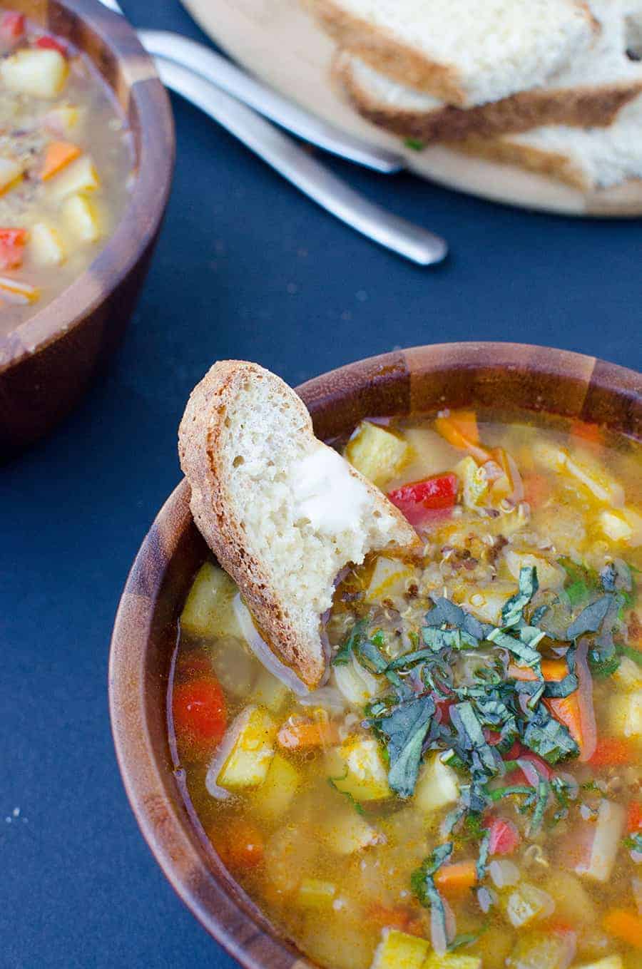 Simple Vegetable Soup Served Over Quinoa With Fresh Bread