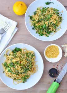 Collard Green Pasta! Shredded collards tossed with hot pasta, garlic, olive oil, red pepper flakes and seasoned bread crumbs. Dinner is ready in just 20 minutes! Vegan | www.delishknowledge.com