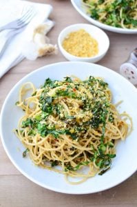 Collard Green Pasta! Shredded collards tossed with hot pasta, garlic, olive oil, red pepper flakes and seasoned bread crumbs. Dinner is ready in just 20 minutes! Vegan | www.delishknowledge.com