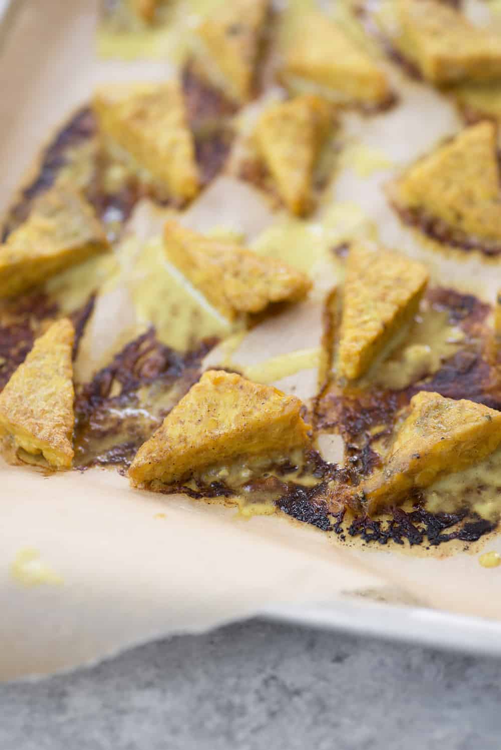 curry tempeh triangles on a baking sheet