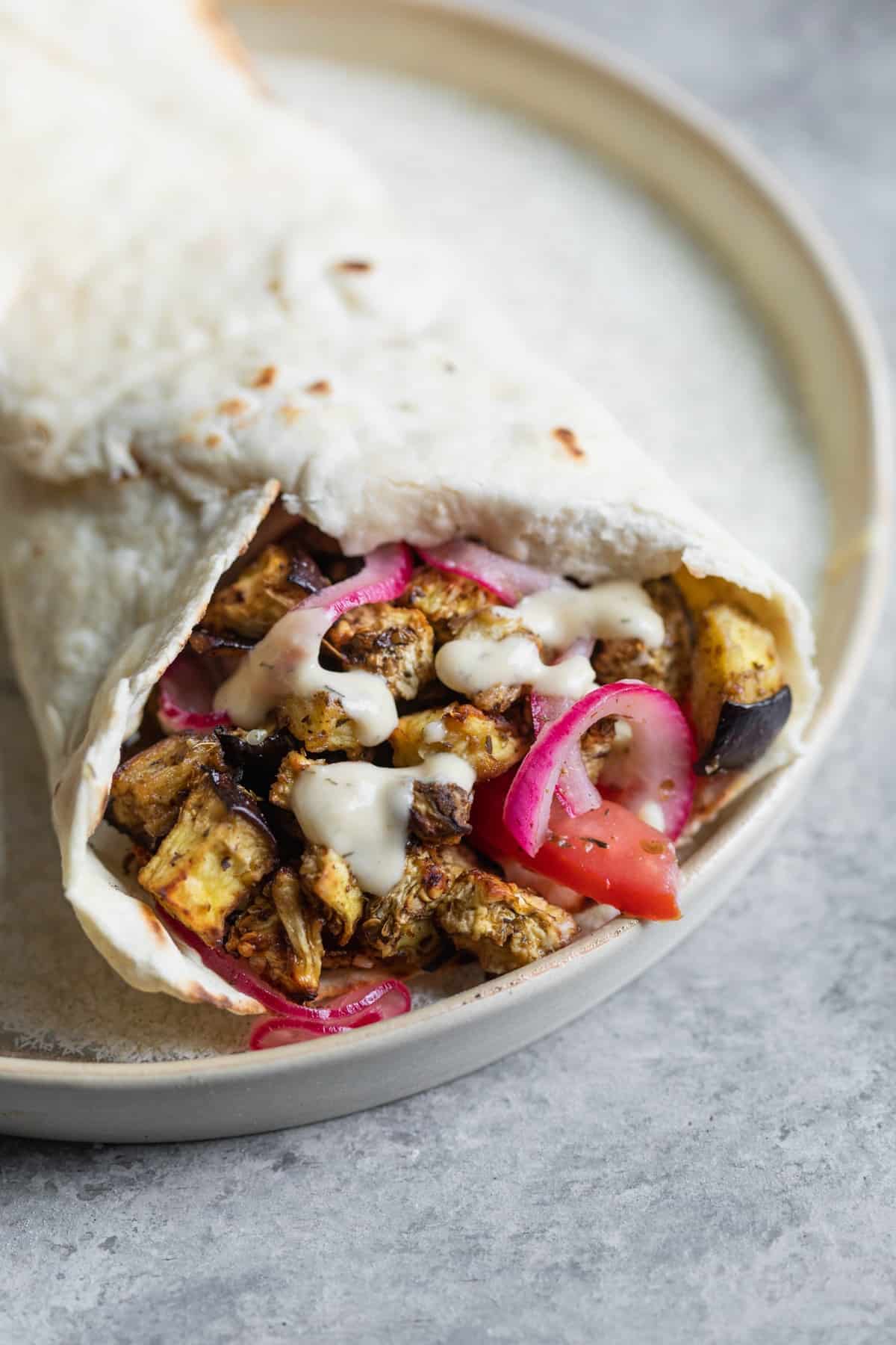 Vegan Eggplant Gyros 3 Vegetarian Gyros With Hummus Sauce On A Plate