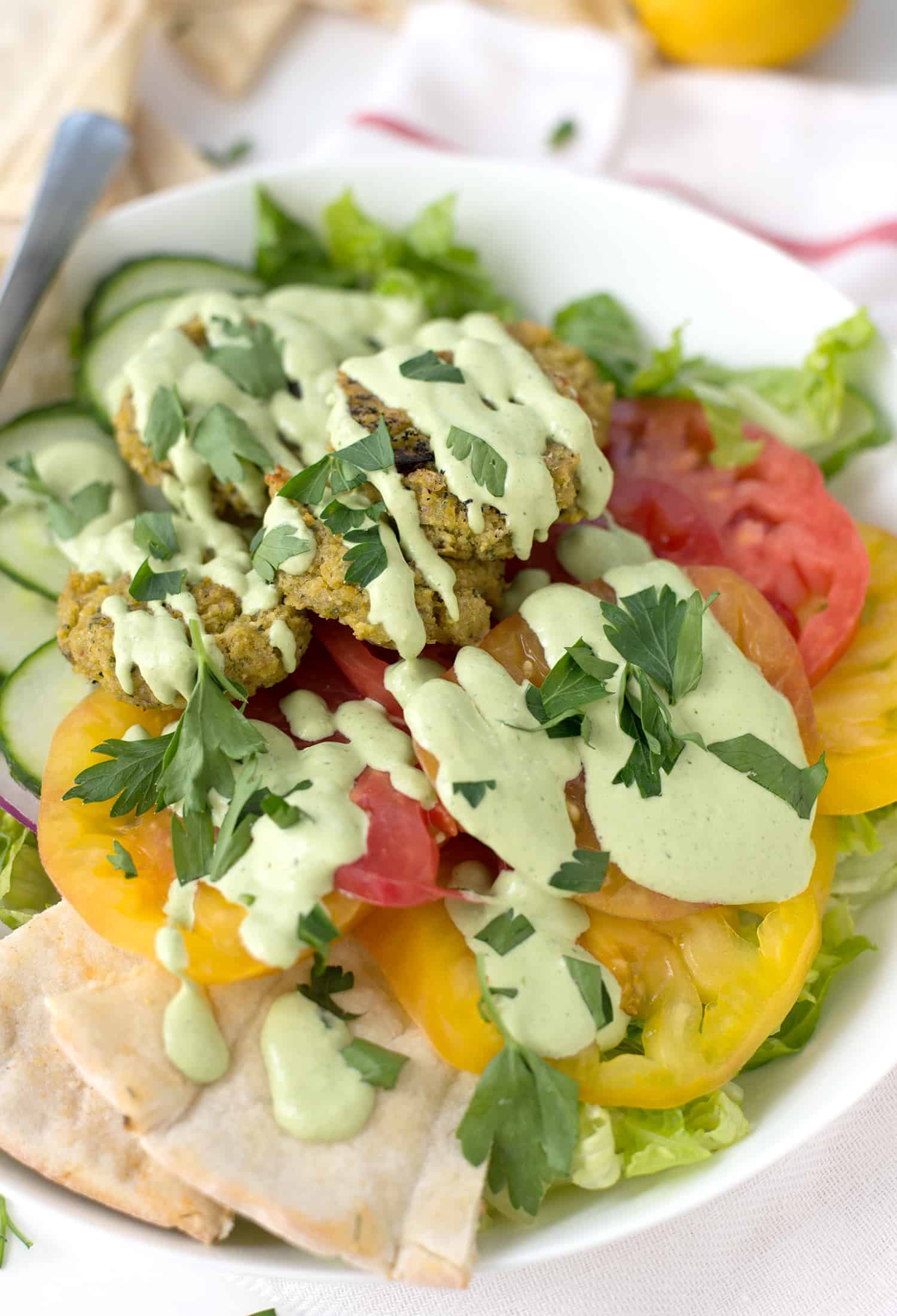 Falafel Salad With Tahini Parsley Dressing! Crispy Vegan Falafel Patties On Top Of Salad With Tahini Parsley Dressing. | Www.delishknowledge.com