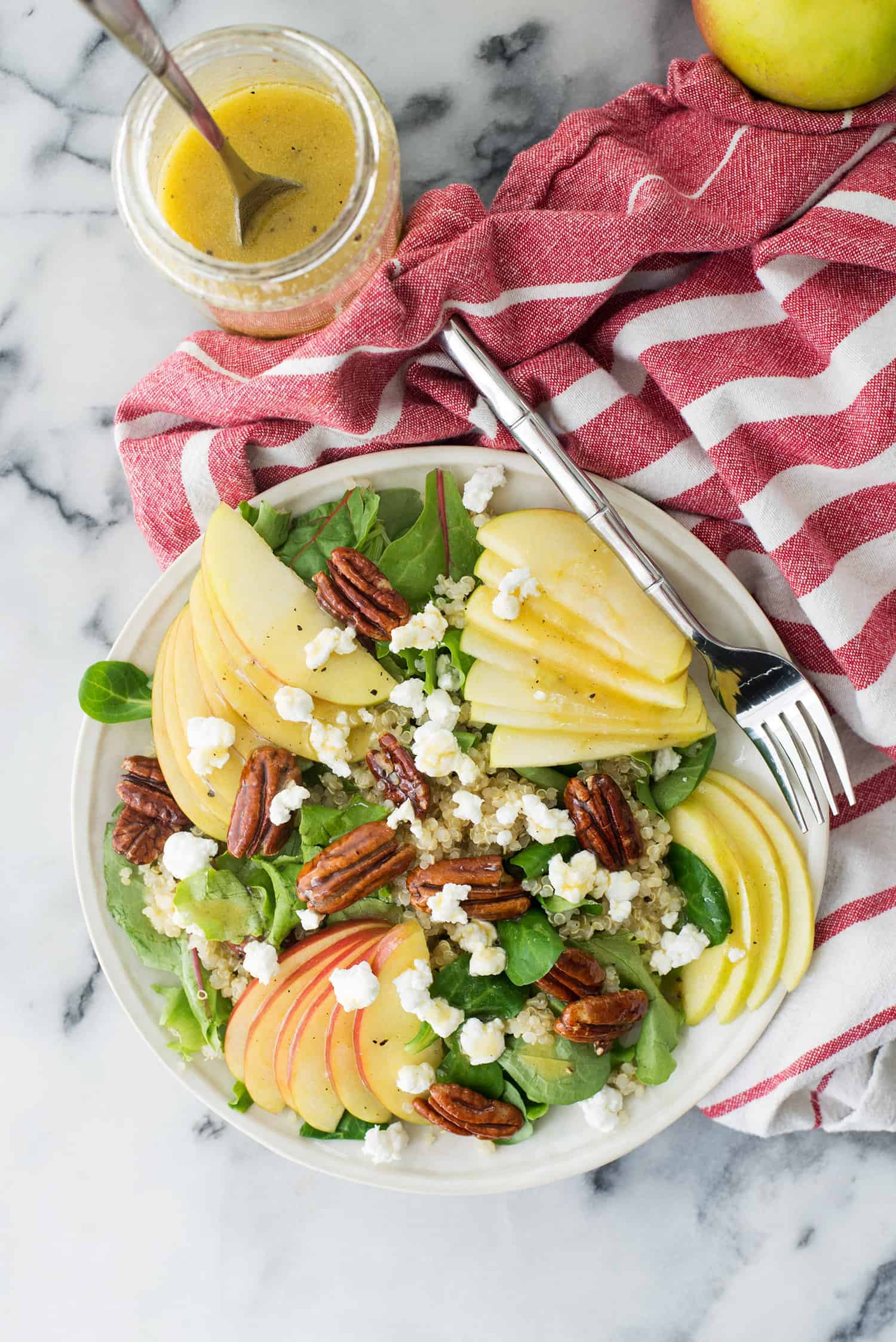 Fall Harvest Salad! A must make this fall. Mache lettuce, quinoa, apples, goat cheese, homemade honeyed pecans and a simple apple cider dressing. Vegetarian and Gluten-Free. | www.delishknowledge.com