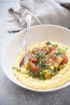 Fresh Corn Polenta with Farm Vegetables and Spicy Basil Oil. The vegan and gluten-free dinner is perfect for summer! Make the most of farmer's market produce; fresh corn polenta topped with sauteed farm vegetables and a drizzle of spicy basil oil. | www.delishknowledge.com