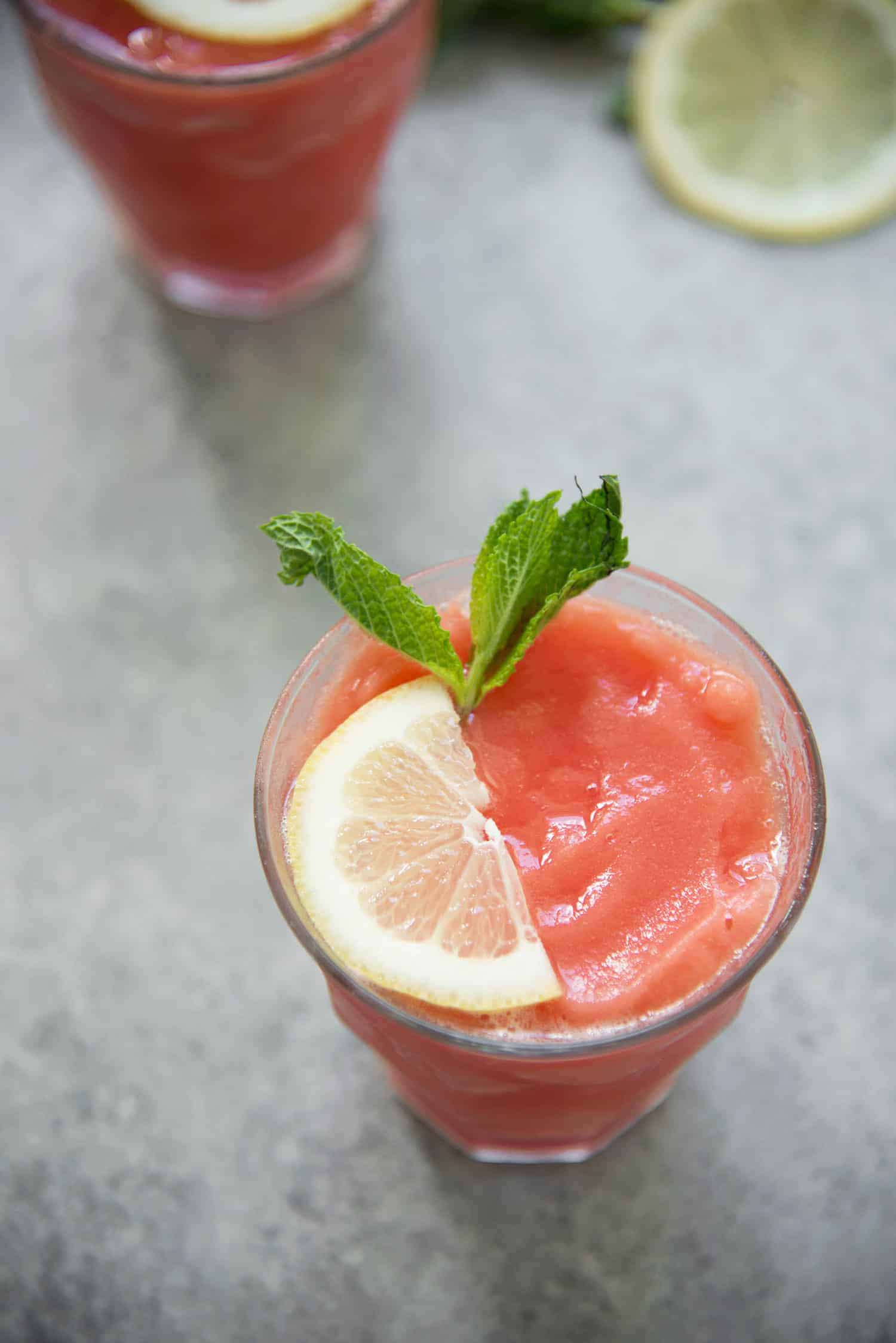 Frozen Watermelon Lemonade Slushies! These refreshing beverages are perfect for hot summer days. Mint, lemon and watermelon pureed together to create a thick and frosty beverage. Enjoy with or without alcohol! vegan, vegetarian, gluten-free | www.delishknowledge.com