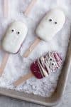 Açai Popsicles on a Baking Sheet with Chocolate and Candy Eyes