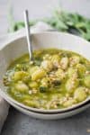 Gnocchi Pesto Soup! This creamy pesto soup is loaded with herbs, zucchini and pillowy gnocchi. Vegan | www.delishknowledge.com