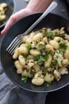 Vegan Gnocchi with Roasted Cauliflower and Lemon! This dinner is perfect for fall; crispy roasted cauliflower, capers, garlic breadcrumbs, gnocchi and fresh lemon juice. A must-make. | www.delishknowledge.com
