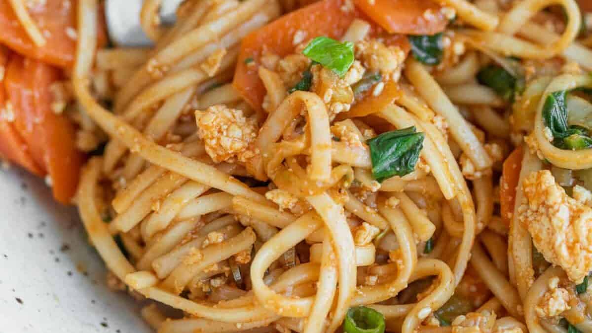 close up of spicy noodles with bok choy and carrots