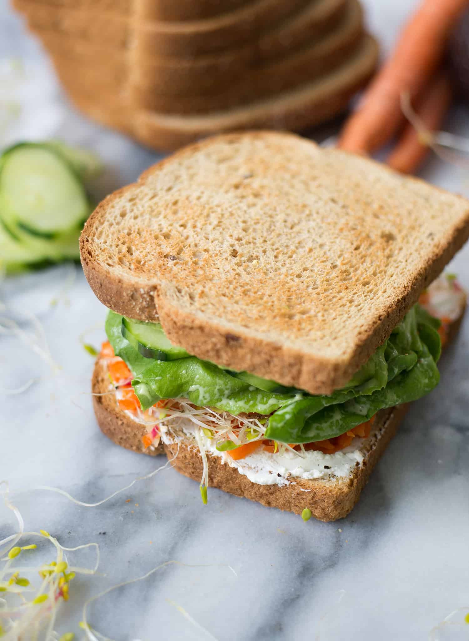 Green Goddess Veggie Sandwich! This Sandwich Is Layered With Flavor And Packed With Vegetables! Homemade Green-Goddess Dressing, Tomatoes, Sprouts, Avocado, Goat Cheese, Radish, Carrots. Vegetarian, Easily Vegan Or Gluten-Free. | Www.delishknowledge.com