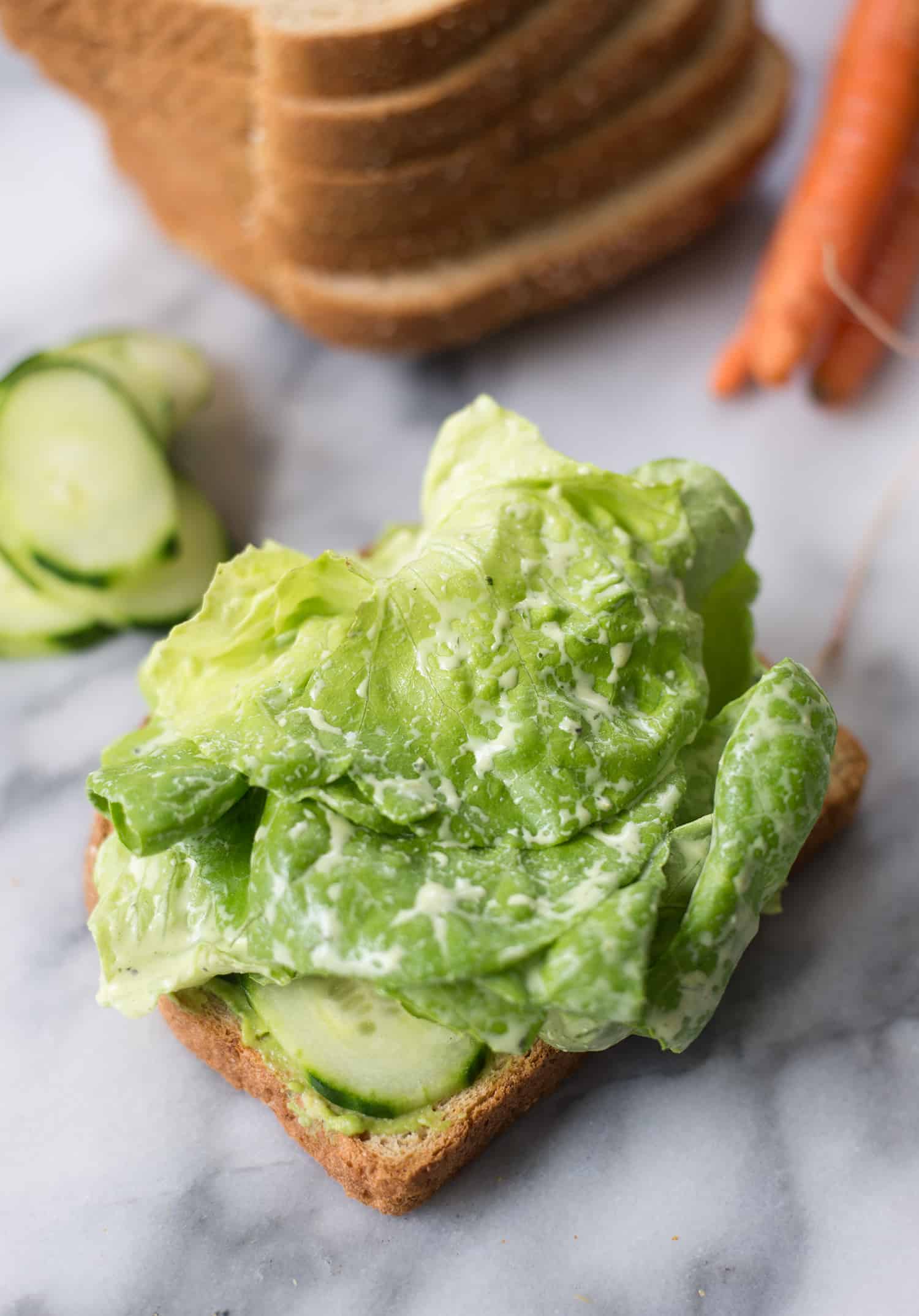 Green Goddess Veggie Sandwich! This Sandwich Is Layered With Flavor And Packed With Vegetables! Homemade Green-Goddess Dressing, Tomatoes, Sprouts, Avocado, Goat Cheese, Radish, Carrots. Vegetarian, Easily Vegan Or Gluten-Free. | Www.delishknowledge.com