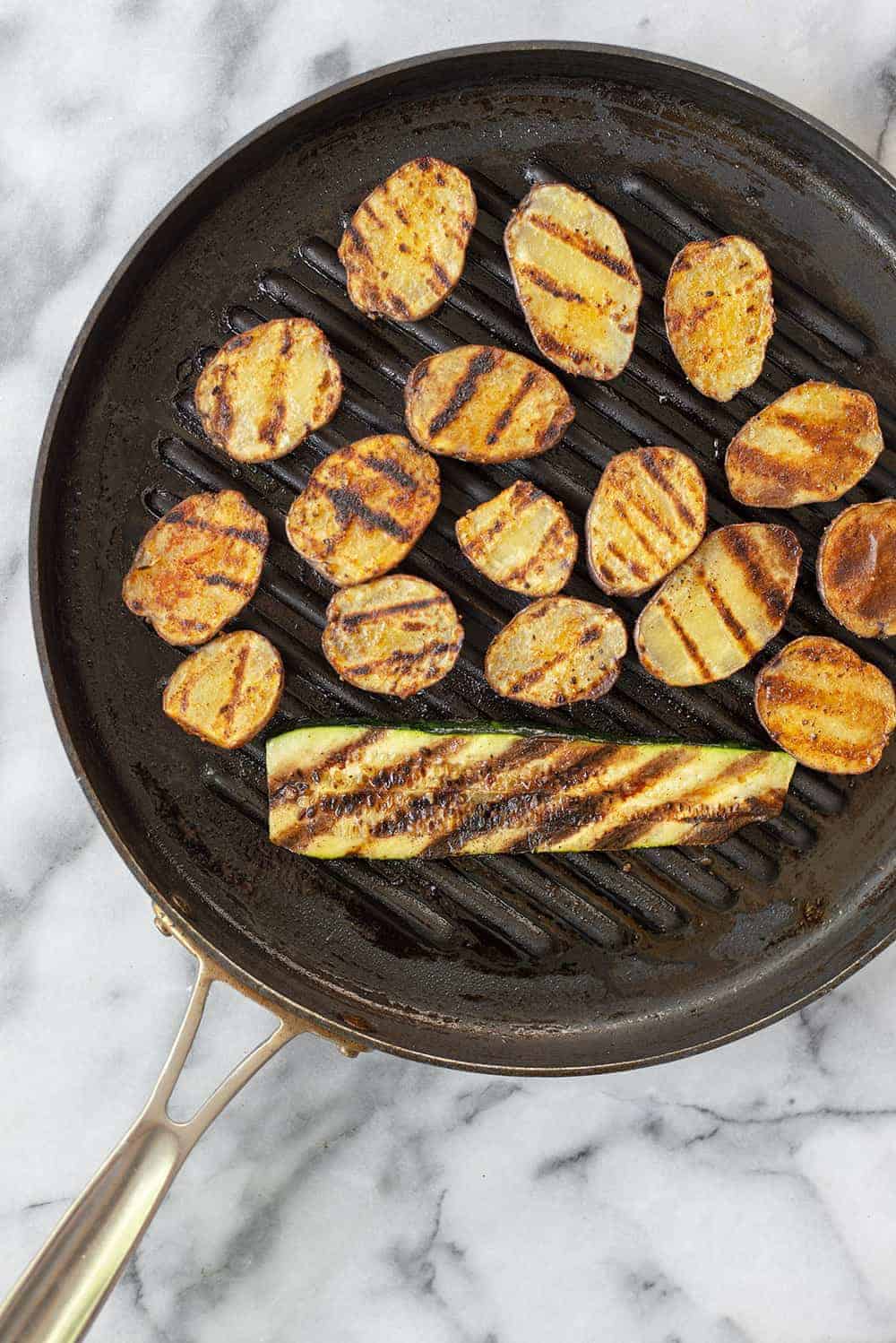 grill pan with potatoes and vegetables 