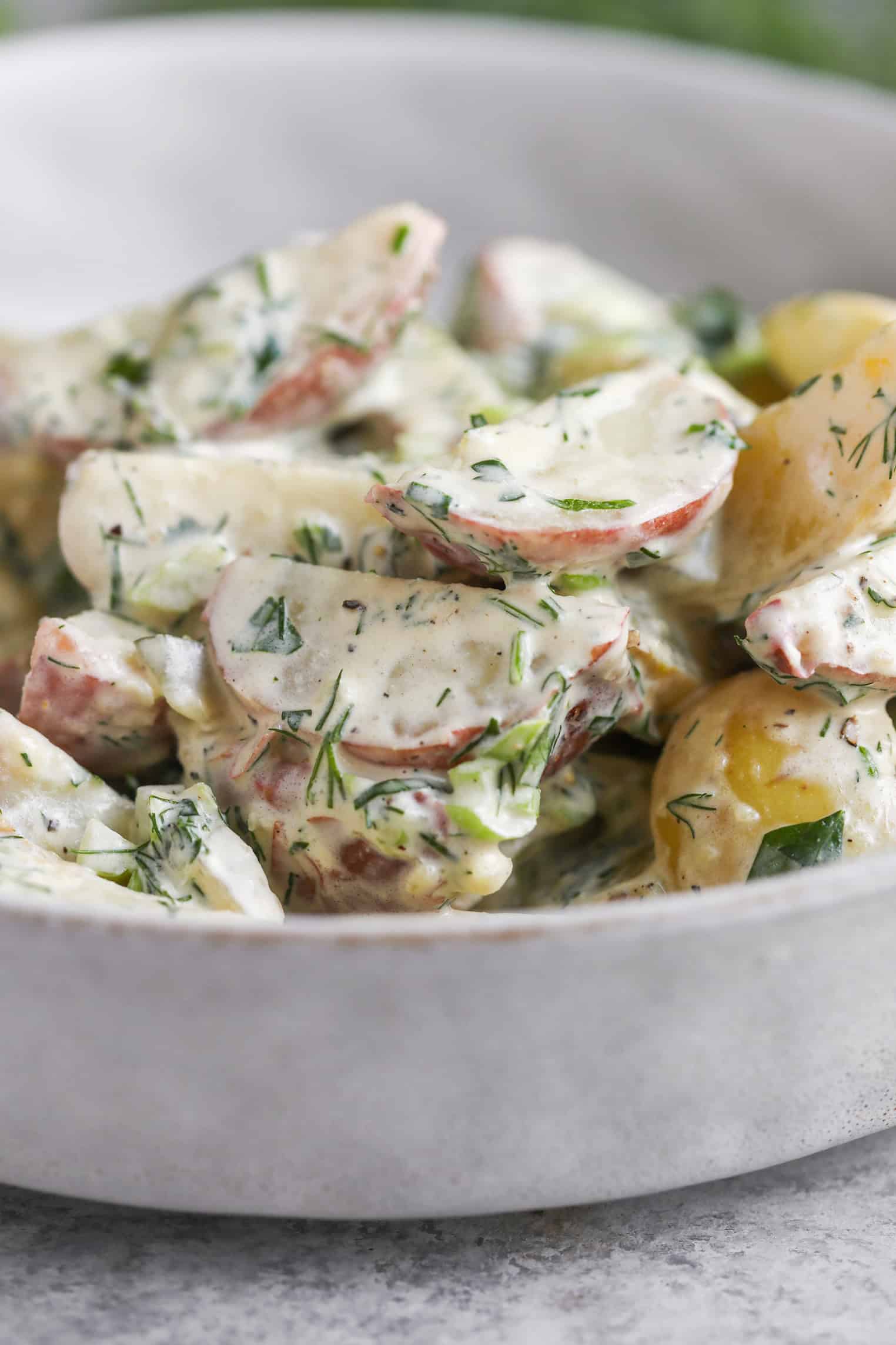 Creamy Herbed Potato Salad 10 A Close-Up Of Herbed Potato Salad With Red-Skinned Potatoes, Fresh Herbs, And A Thick Dressing, Served In A Light-Colored Bowl.