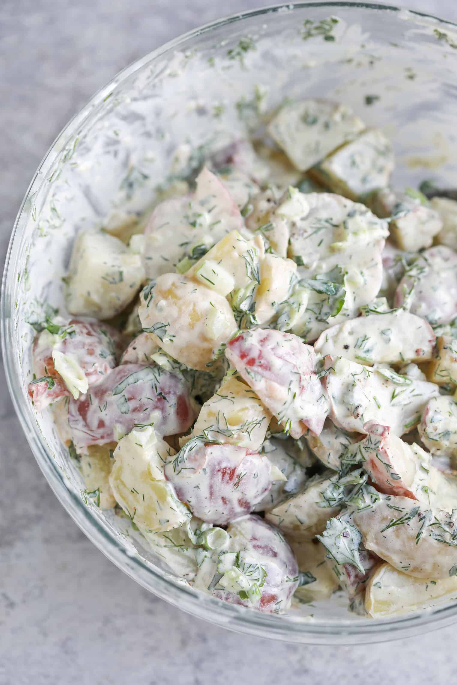 Creamy Herbed Potato Salad 11 A Glass Bowl Filled With Creamy Herbed Potato Salad Featuring Chunks Of Red And Yellow Potatoes, Fresh Dill, And A White Dressing.