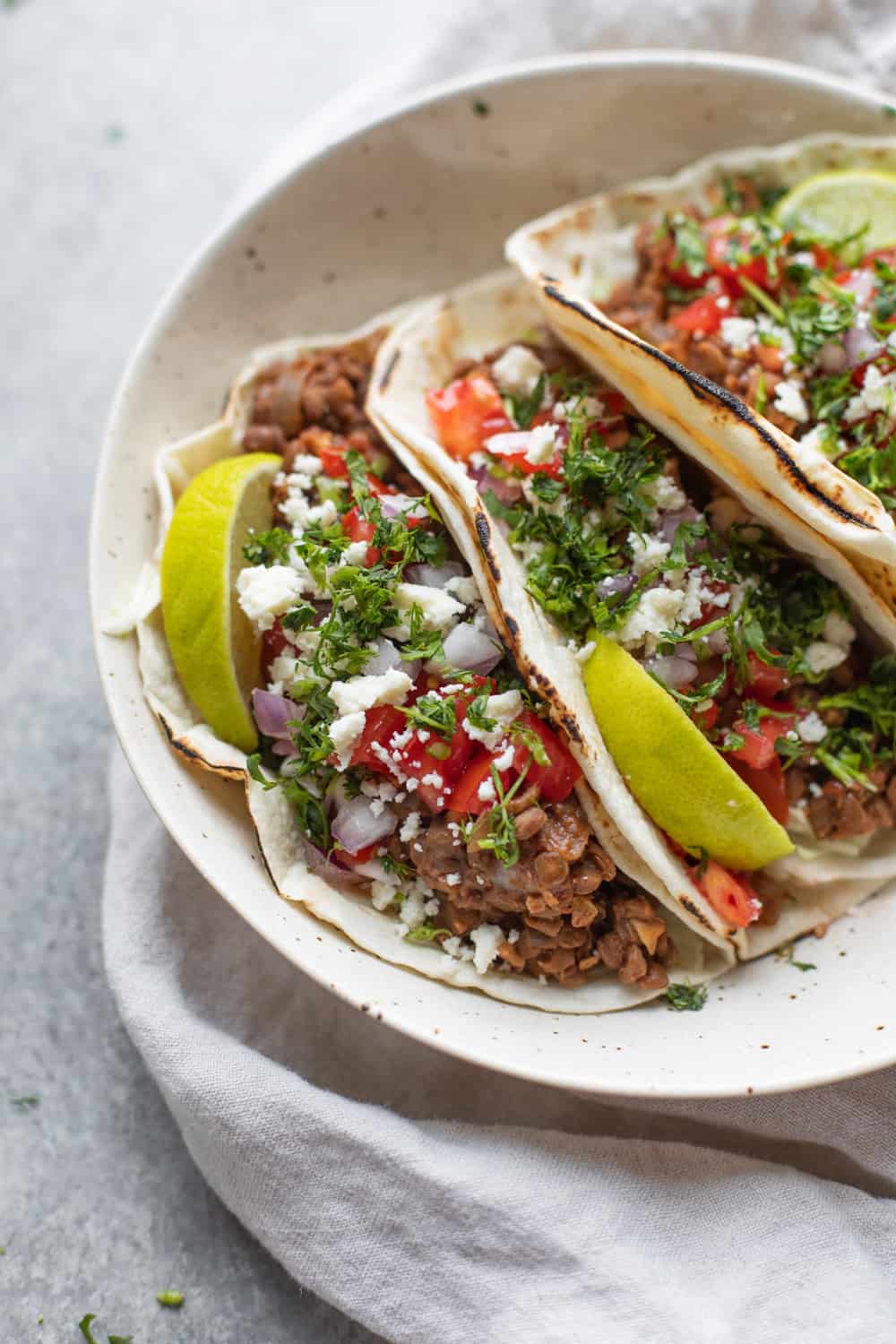 Instant pot lentil walnut tacos on plate with lime