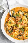 Close up of shot of tortellini in tomato broth