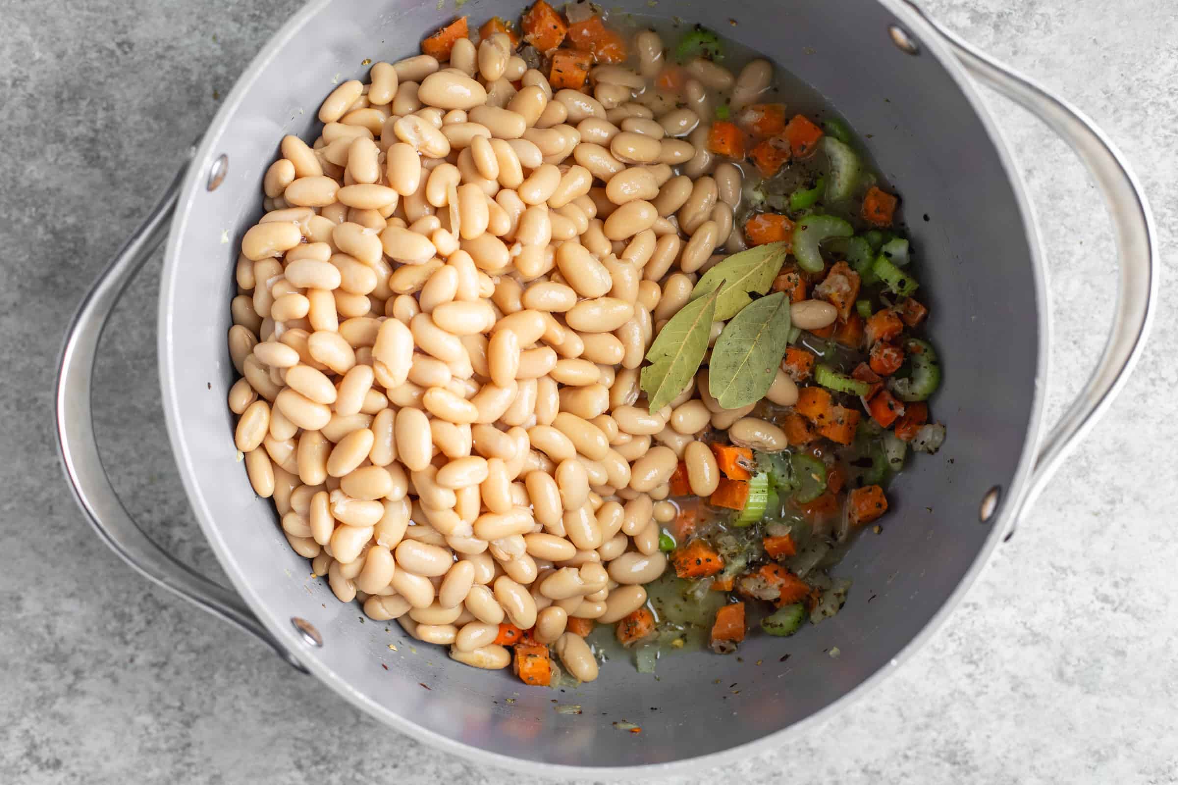 Italian white bean soup in a saucepan
