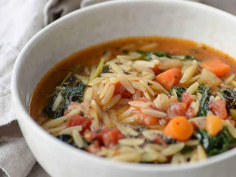 Bowl Of Vegan Italian Kale And Orzo Soup