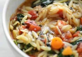 close up bowl of vegan kale and orzo soup