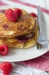 Lemon Raspberry Pancakes, perfect for Valentines Day brunch! Soft and fluffy pancakes infused with lemon zest and frozen raspberries. | www.delishknowledge.com