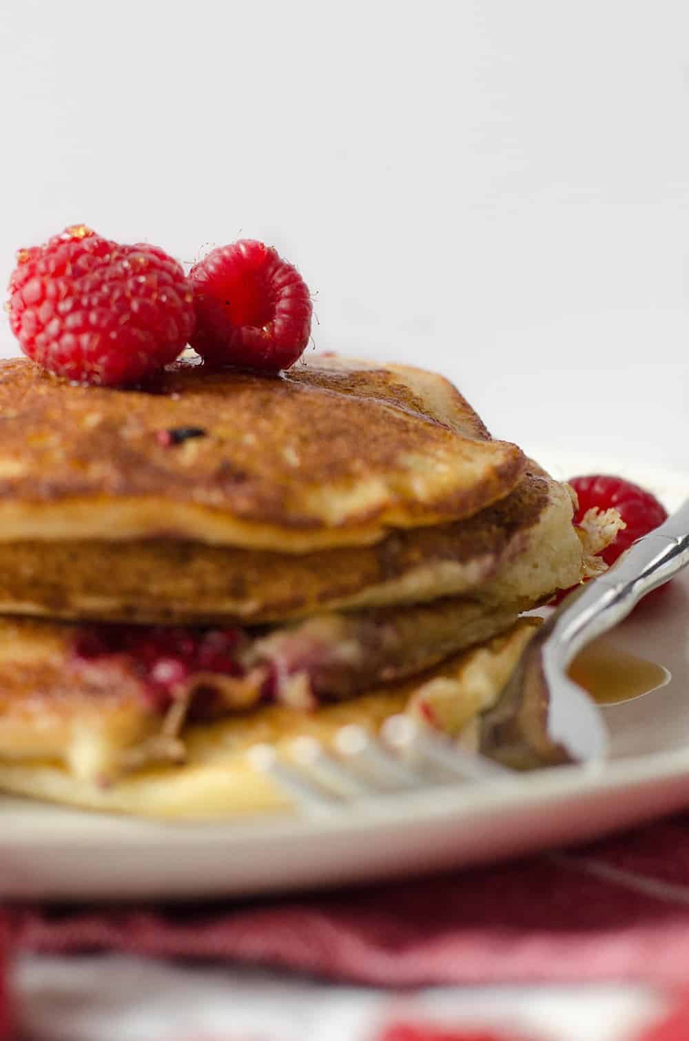 Lemon Raspberry Pancakes, Perfect For Valentines Day Brunch! Soft And Fluffy Pancakes Infused With Lemon Zest And Frozen Raspberries. | Www.delishknowledge.com